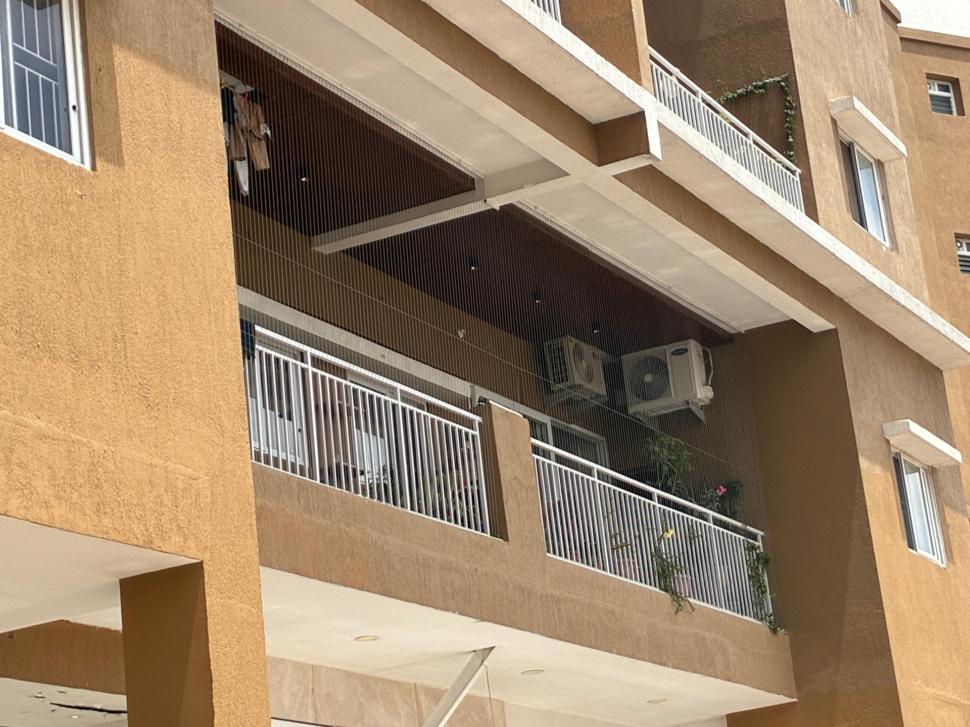 Apartment balcony outside view – invisible grill installation by HomeNest Invisible Grills