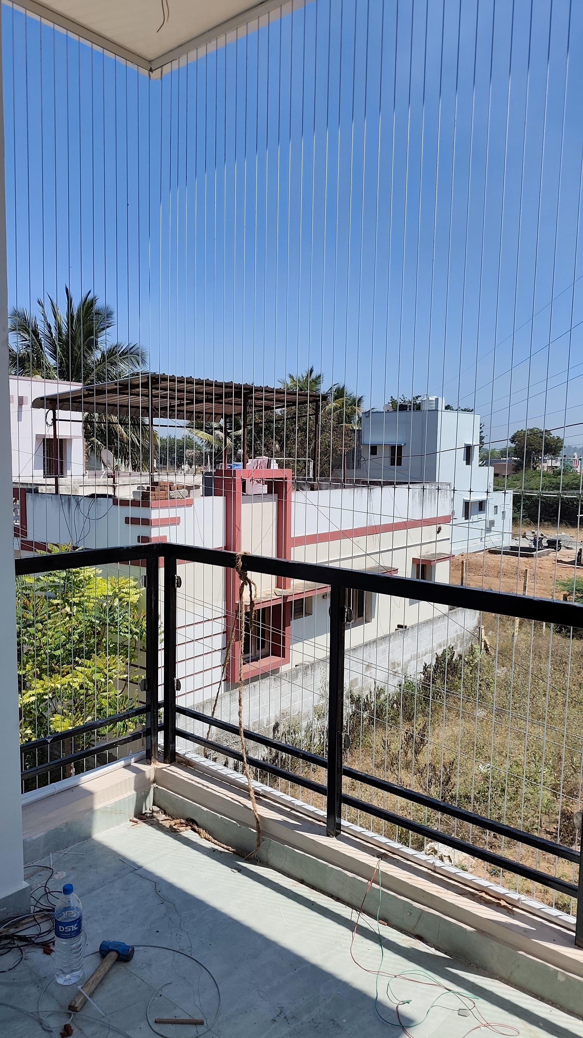 Independent house corner balcony – invisible grill installation by HomeNest Invisible Grills
